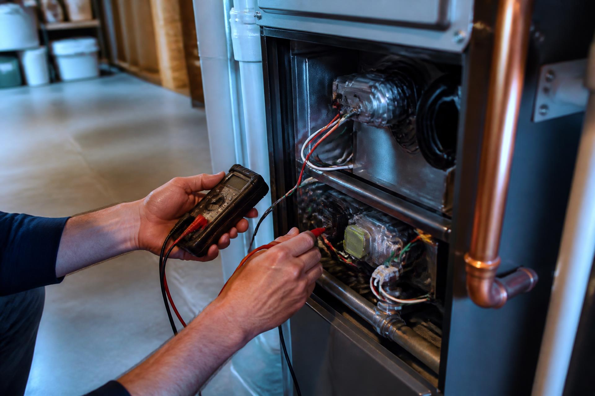 Technician servicing a high-efficiency furnace